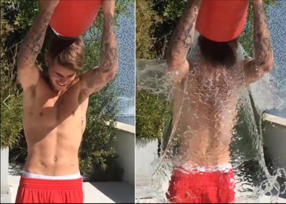 Award winning Justin Bieber dunks himself in a bucket of water.