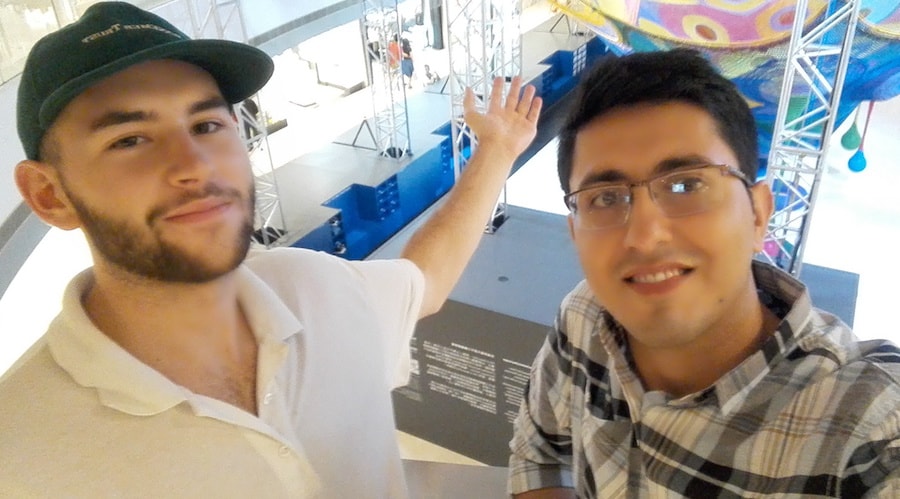 Two men capturing an award-winning selfie in a museum, showcasing their prowess in digital marketing.