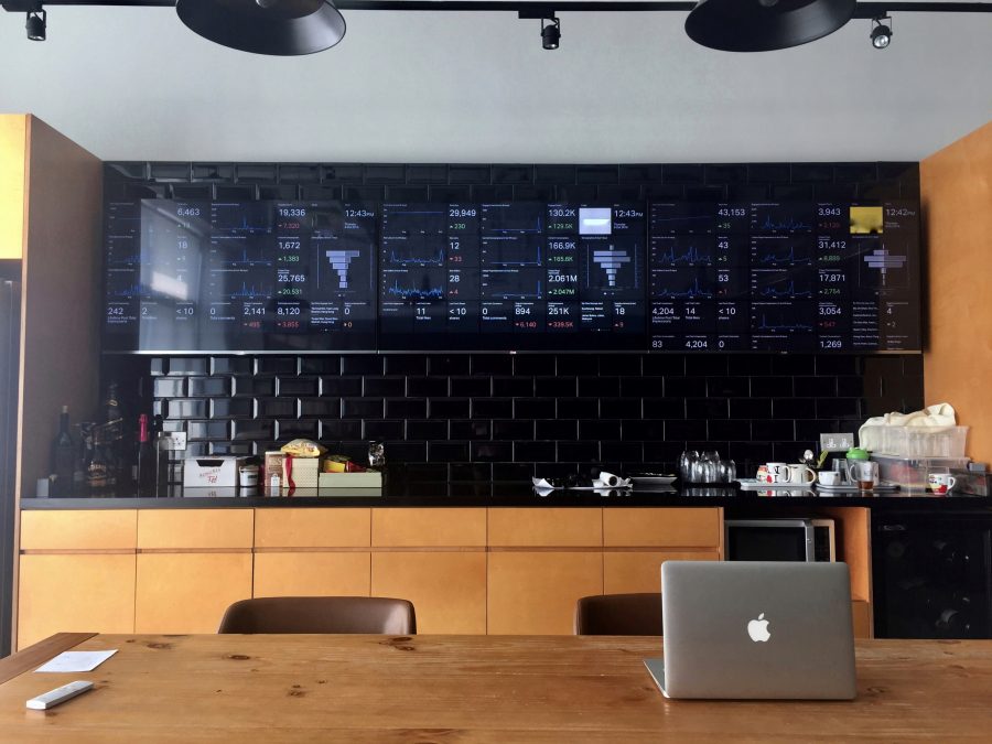 A laptop on a table next to a black wall in Hong Kong.