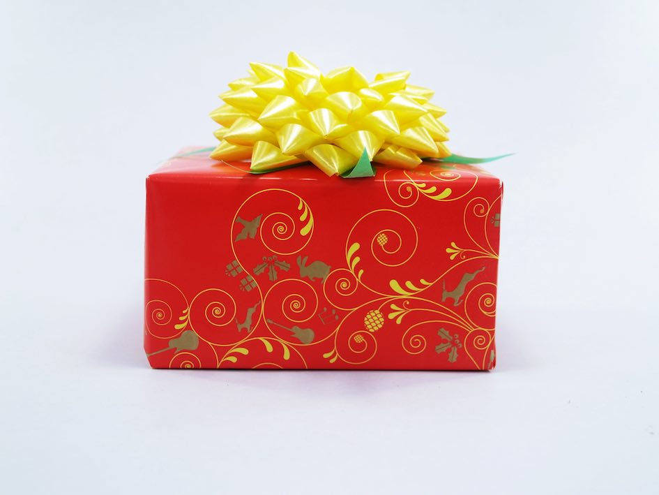 An award-winning red gift box from Hong Kong with a yellow flower on it.