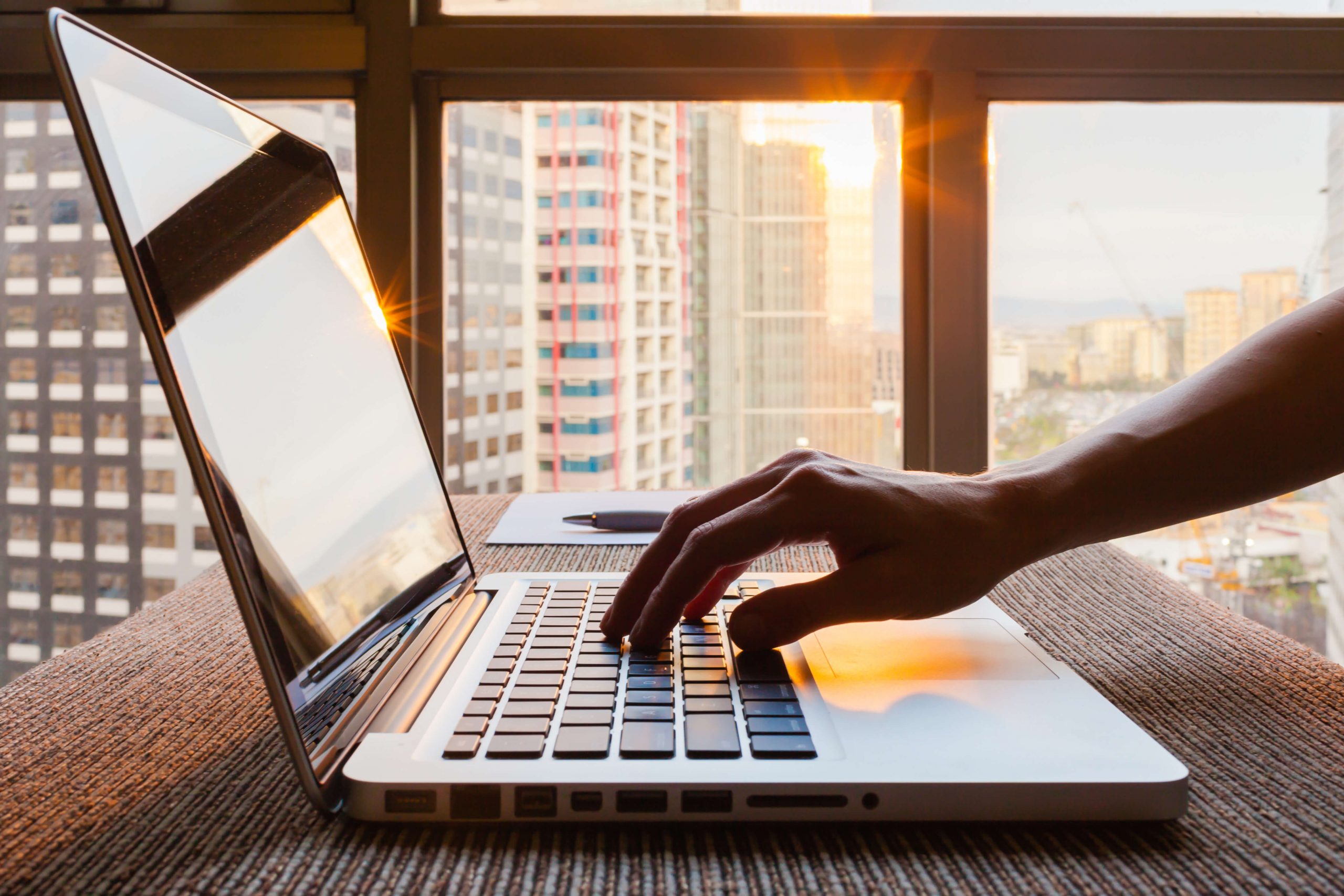 A person executing digital marketing strategies in front of a window.