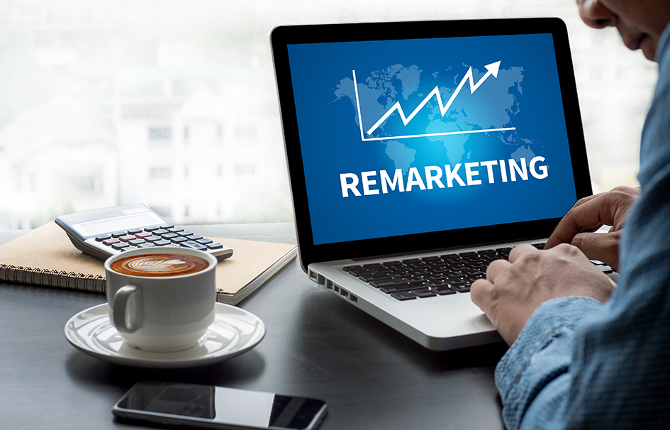 A man in Hong Kong working on a laptop with the word remarketing displayed, specializing in digital marketing and SEO.