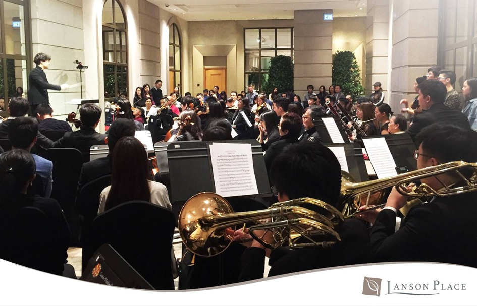 A group of people in Hong Kong sitting in a room with an orchestra.