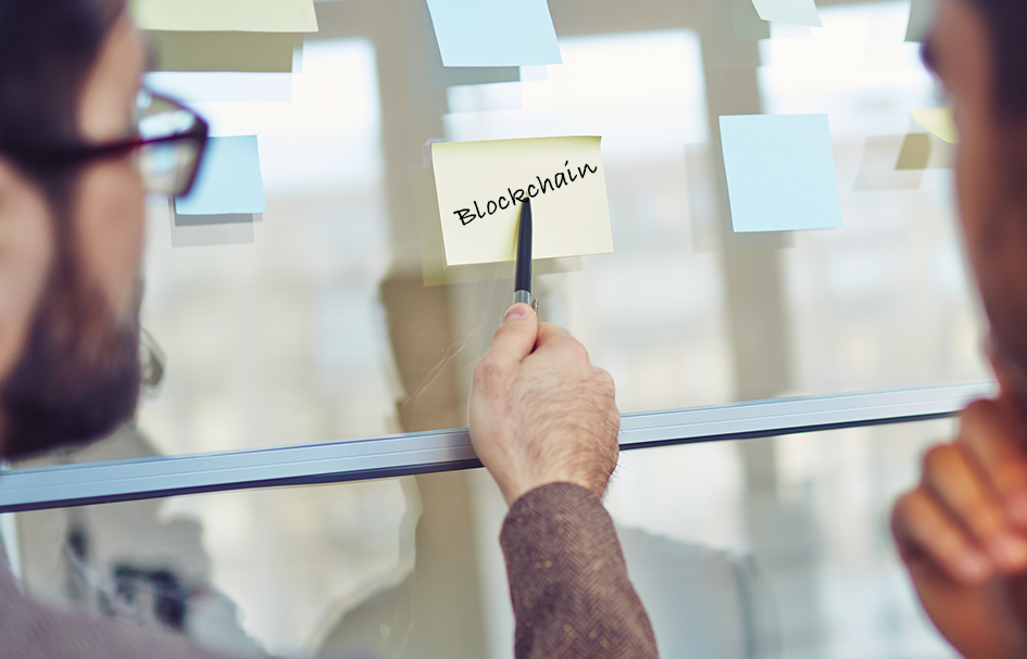 Two award-winning professionals in Hong Kong utilizing sticky notes on a glass wall for digital marketing strategies.