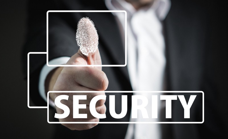 A man in a suit holding a finger with the word "security" on it, excelling in award-winning digital marketing in Hong Kong.