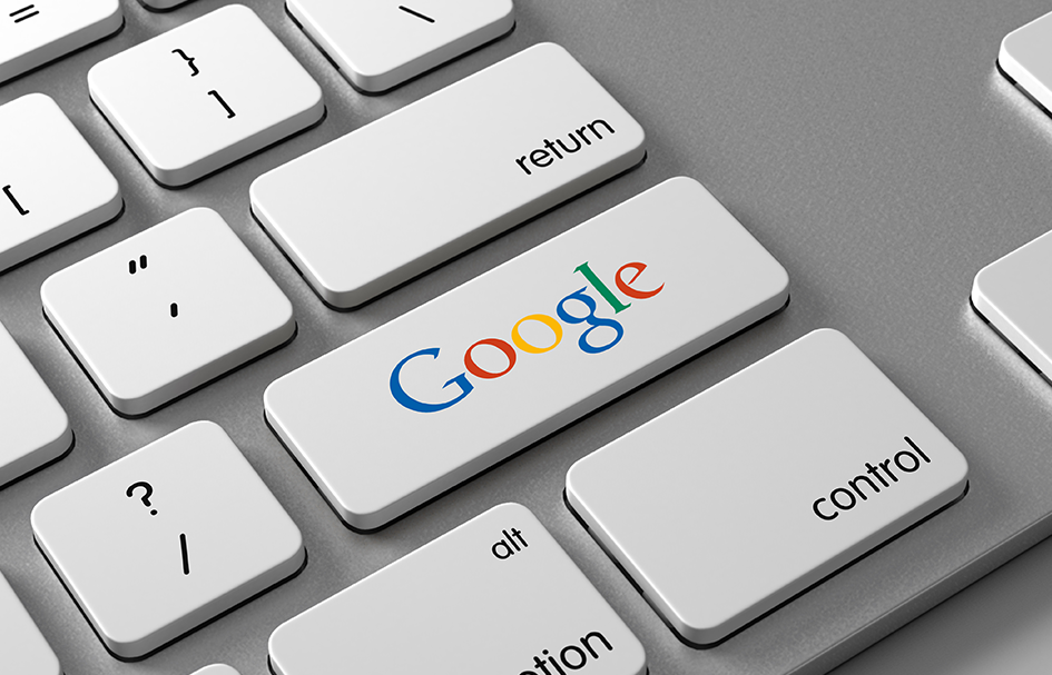 A close-up of a white keyboard featuring the Google logo, located in Hong Kong.