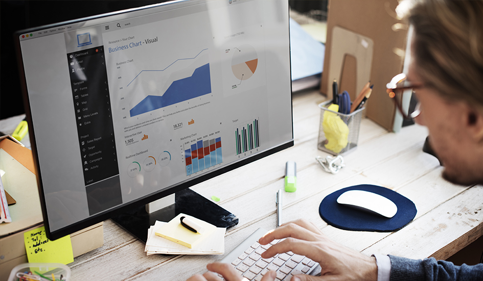 A digital marketing specialist from Hong Kong analyzing award-winning graphs on his computer screen.