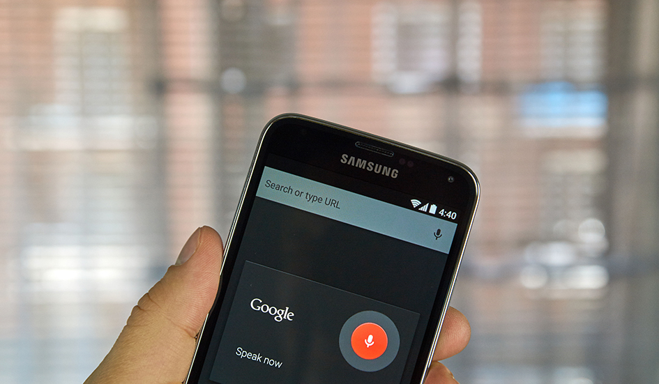 A person in Hong Kong is holding up a Samsung phone with Google voice on it.