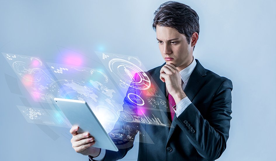 A suit-clad businessman engaging in digital marketing by examining a tablet.