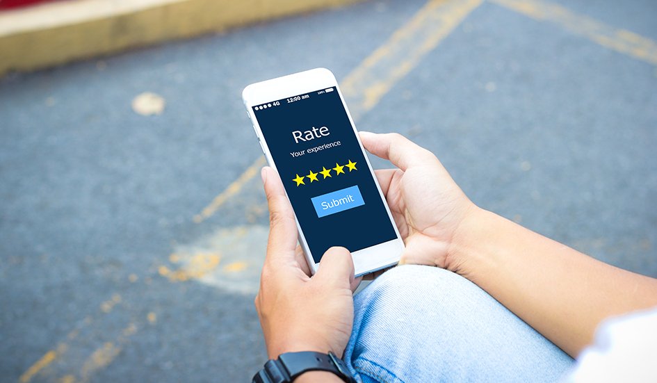 A person in Hong Kong holding a smartphone with an award-winning rating app on it.