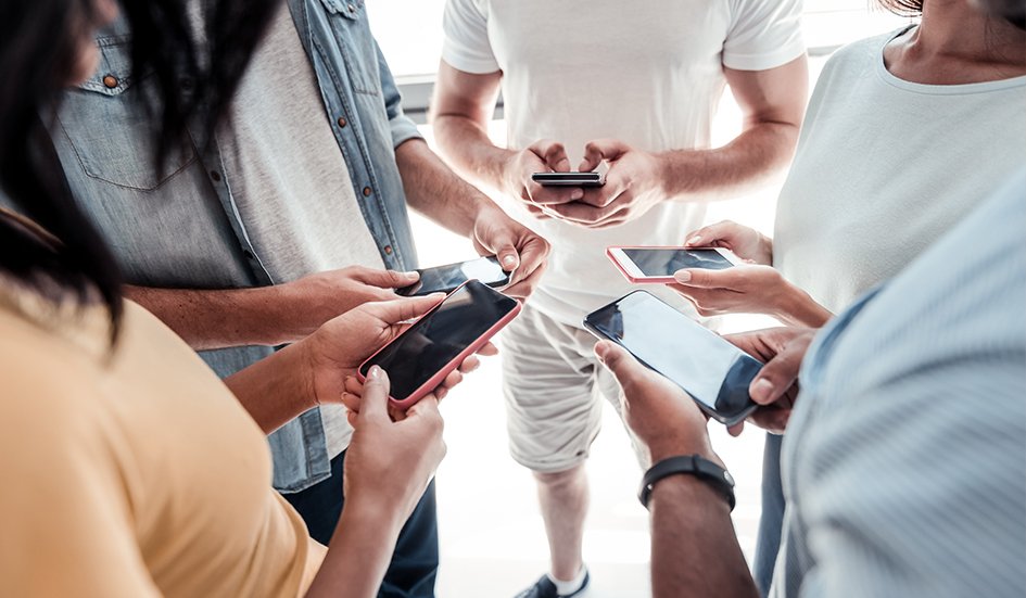 A group of award-winning people in Hong Kong looking at their phones for SEO purposes.